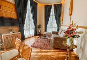 a living room with a couch and a table at Grand Lord Hotel & Residence in Na Jomtien