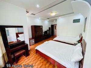 a bedroom with a bed and a mirror and a piano at BB House Hotel Đ&agrave; Lạt in Da Lat