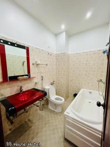 a bathroom with a red sink and a toilet at BB House Hotel Đ&agrave; Lạt in Da Lat