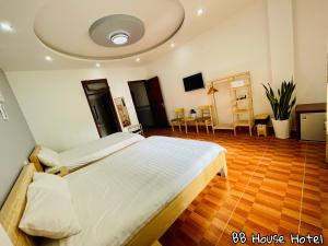 a large bedroom with two beds and a wooden floor at BB House Hotel Đ&agrave; Lạt in Da Lat