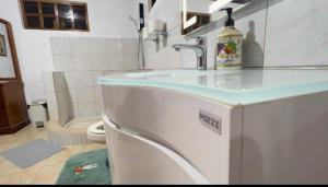 a bathroom with a sink and a toilet at Ohana Hometel in Sorsogon