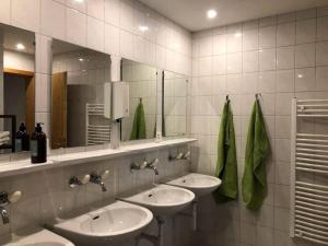a bathroom with three sinks and a mirror at Alte Sennerei in Ober-Says +24 photos
