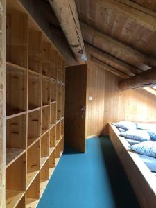 a room with wooden shelves and a room with pillows at Alte Sennerei in Ober-Says