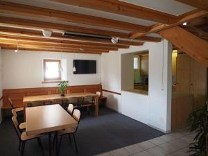 a dining room with tables and chairs and a tv at Alte Sennerei in Ober-Says