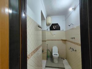 a bathroom with a white toilet in a room at Kiran Lake Paradise Homestay in Bhīm Tāl