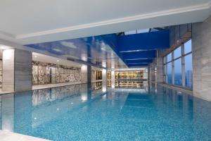 - une piscine dans un bâtiment avec vue dans l'établissement HUALUXE Leshan, an IHG Hotel, à Leshan