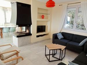 a living room with a couch and a fireplace at Vaste villa en position dominante superbe vue lacs in Hautecour