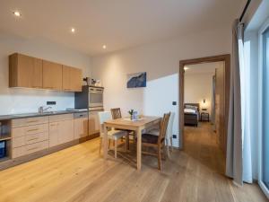 a kitchen and dining room with a table and chairs at Bergzeit Appartement in Hopfgarten im Brixental