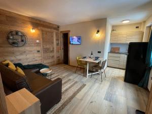 a living room with a couch and a table at Apartment Gran Baita Sauze d'Oulx in Sauze dʼOulx