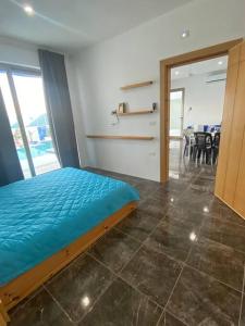 a bedroom with a bed and a view of a dining room at Aqua Blue Villa-Dead Sea, Jordan in Amman