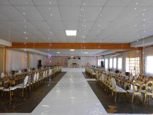 an empty banquet hall with tables and chairs at Noma-Nini Lodge in White River