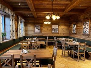 a dining room with wooden tables and chairs at Bio - Hotel - Alpengasthof Koralpenblick in Deutschlandsberg