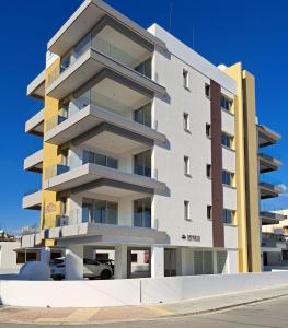 a tall building with balconies on the side of it at ICEBUILD APARTMENTS in Nicosia