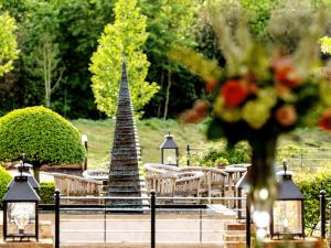 a garden with a christmas tree and chairs and a centerpiece at The Old Hall Ely in Ely