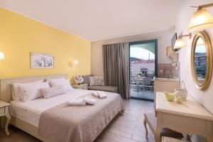 a hotel room with a bed and a balcony at Villa Anthelion in Limenaria