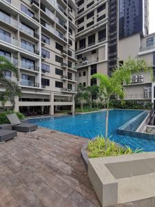 a swimming pool in front of a building at Baseline Premier - Studio with mountain view in Cebu City