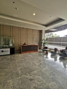 a lobby with a reception desk in a building at Baseline Premier - Studio with mountain view in Cebu City