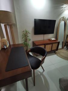 a living room with a table and a chair at Baseline Premier - Studio with mountain view in Cebu City