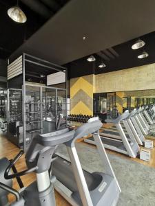 a gym with a row of treadmills and ellipticals at Baseline Premier - Studio with mountain view in Cebu City