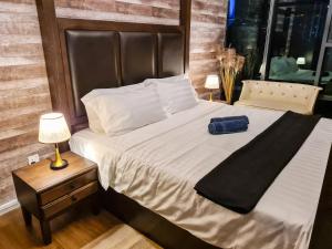 a bed with a blue bag sitting on top of it at Romantic Log Cabin - walk to KL Tower, KLCC, Bukit Bintang in Kuala Lumpur