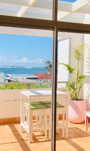 a room with a table and a view of the ocean at Seaspray Villa 5 in Shoal Bay