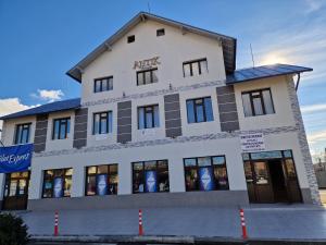 a white building with a sign on it at ANTIK HOUSE in Cornu de Jos