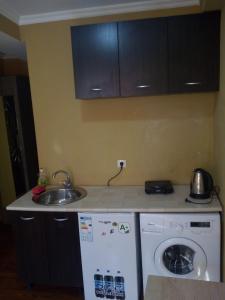 a kitchen with a sink and a washing machine at vake-house in Tbilisi City