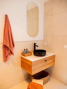 a bathroom with a sink and a mirror at Luxurious Waterfront home in the North of Hobart in Hobart