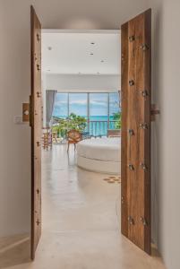 ein Schlafzimmer mit Bett und Blick auf das Meer in der Unterkunft Ampersand Resort in Bophut 