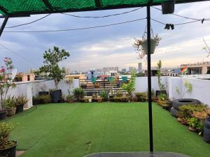 a green lawn on the roof of a building at Private room with Sky Garden in Green Bacchus by Walias in Gurgaon