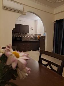 a room with a table with flowers on it at Private room with Sky Garden in Green Bacchus by Walias in Gurgaon