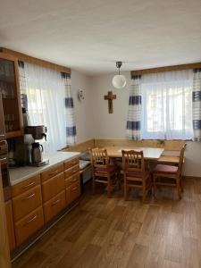 a kitchen with a table and chairs and a cross at Chasetta Zum Sigrist in Galtür