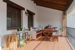 a patio with a couch and a table and chairs at Casa Rural El Abuelo Luis in Molinicos