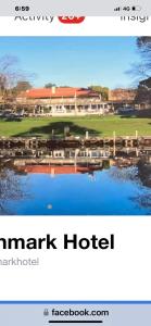 a sign for a marriott hotel with a picture of a lake at Denmark Hotel in Denmark