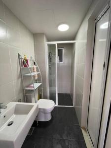 a bathroom with a toilet and a sink and a shower at The Cozy@Southville, Bangi (Netflix/Disney+/Pool) in Kampong Tangkas