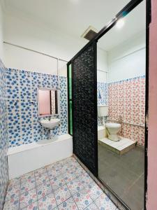 a bathroom with a sink and a toilet at MJ inn in Ranau