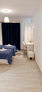 a bedroom with two beds and a desk and a mirror at The Central Villa - Kassiopi Corfu Villas in Kassiopi