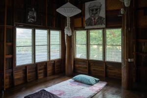 清道的住宿－Art House at Chiangdao - Waterlily House，客房设有窗户和地板上的床垫。