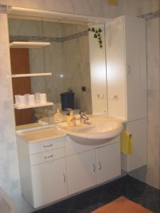 a bathroom with a sink and a mirror at Haus Gilli in Lagundo