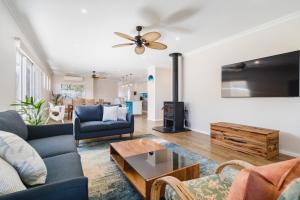 a living room with two couches and a table at AZZURE on WATERVILLE in Dunsborough