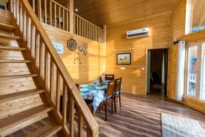 comedor con mesa y escalera en SaffronStays Cottage Glade, Dehradun - luxury wooden cottage, en Dehradun