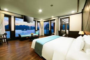 a bedroom with a large bed and a large window at Peony Cruises in Ha Long