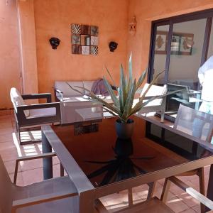 a dining room with a table with a potted plant on it at Luxury large 2 bedroom Apartment short walk to Villamartin Plaza in Villamartin