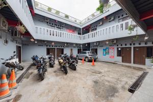 a group of motorcycles parked in a parking lot at RedDoorz near UNSIKA University Karawang in Karawang