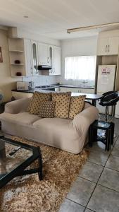 a living room with a couch and a kitchen at Debbie's Den in Springs