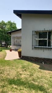 a white building with a window on the side of it at Debbie's Den in Springs