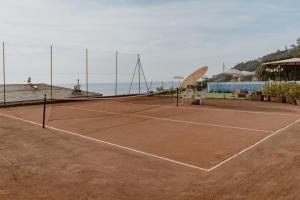 a tennis court with a net on top of it at Villa Solaria in Sori