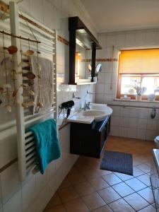 a bathroom with a sink and a mirror at Ferienwohnung HOAMAT Schmalzreich Andrea in Lam