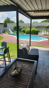 a patio with a table and a bed and a pool at Debbie's Den in Springs