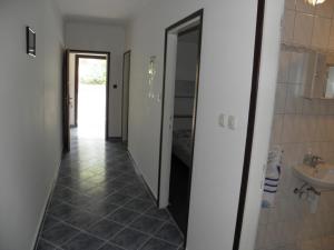 a hallway with a bathroom with a sink and a mirror at Apartment in Lopar with sea view, terrace, washing machine 593-2 in Lopar +33 photos